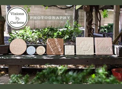 Collection of decorative ceramic tiles displayed on an outdoor bench