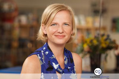 Executive portrait of a woman in a blue patterned dress in a retail setting