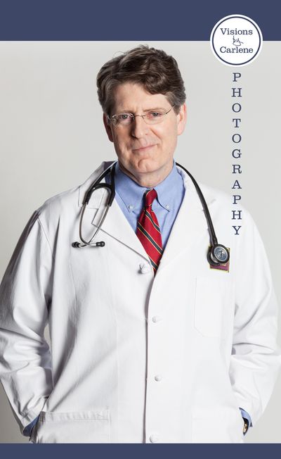 Doctor in a white lab coat with stethoscope and red tie