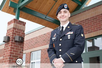 Portrait of a young man in US Army dress uniform outside a brick building