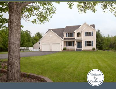 MLS real estate photo of a two-story colonial home with attached garage