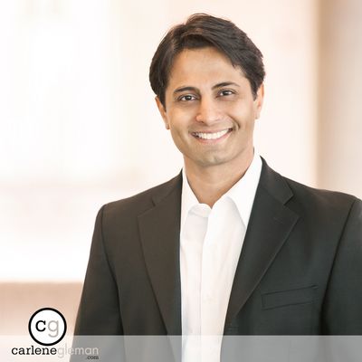 Executive portrait of a man in a dark blazer photographed in natural light